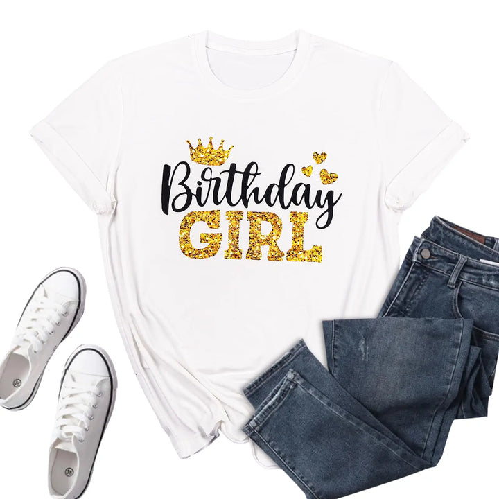 White t-shirt with 'Birthday Girl' text, blue jeans, and white sneakers on a white background