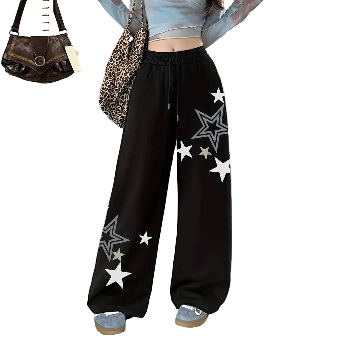 Black wide-leg sweatpants with white and gray star prints, shown on a model wearing a light blue crop top and gray sneakers. A brown leopard-print shoulder bag and a small brown handbag are also shown as styling props against a white background.
