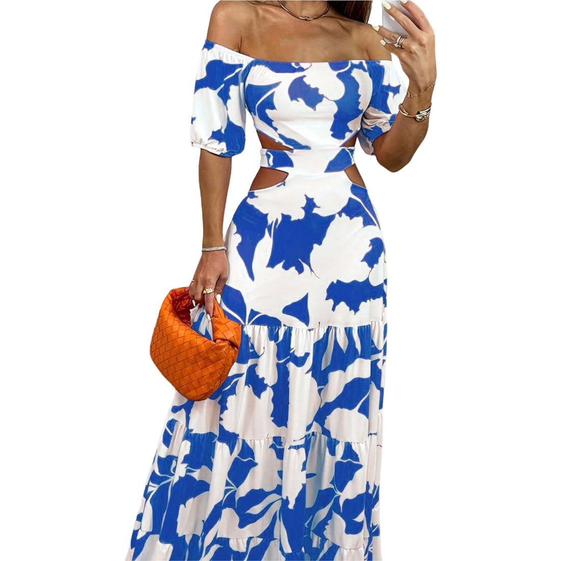 Woman wearing a blue and white floral dress holding an orange clutch.