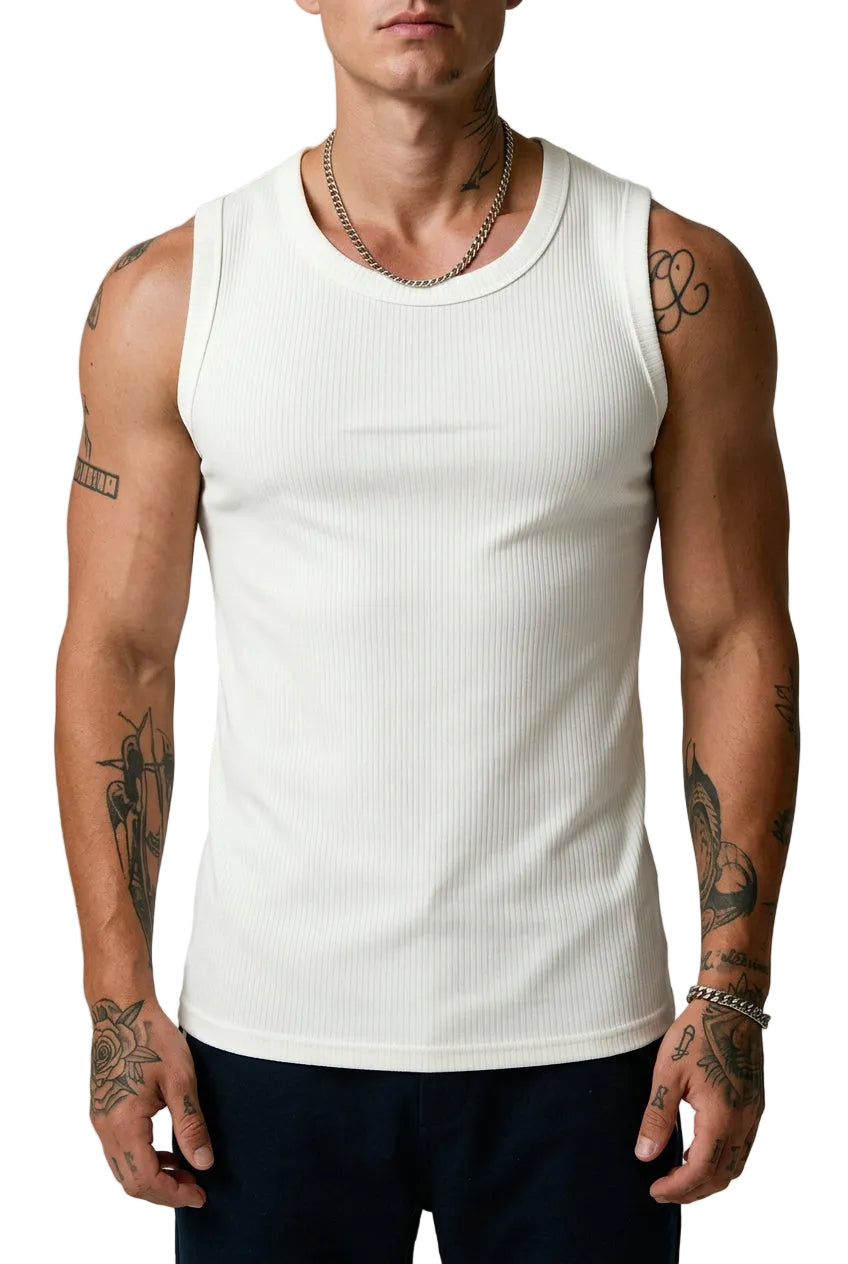 Person wearing a white tank top with visible tattoos on arms