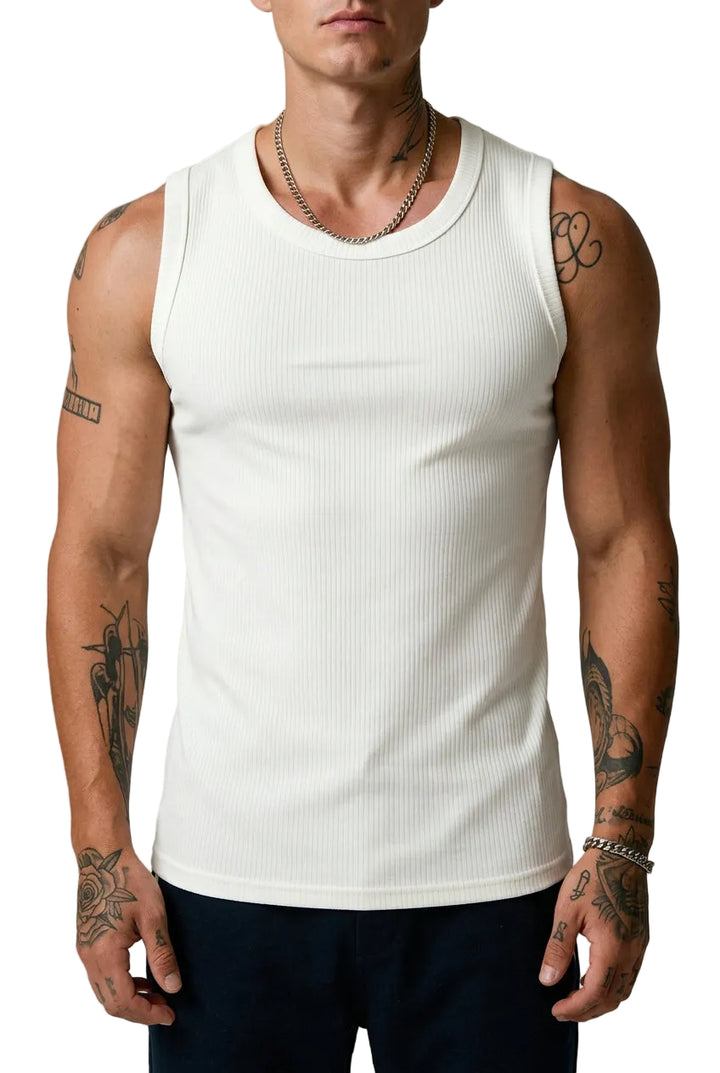 Person wearing a white tank top with visible tattoos on arms