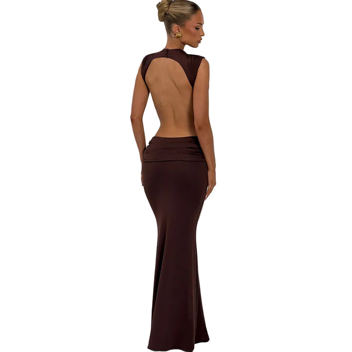 Woman wearing a brown evening gown with an open back against a plain background