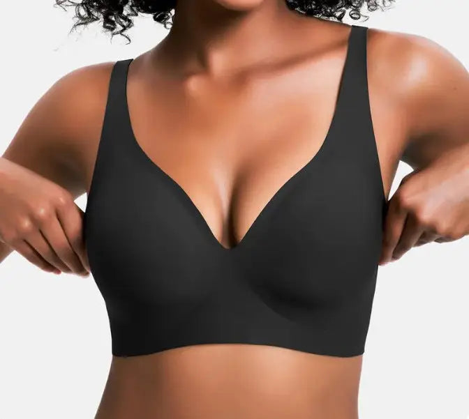 Black bra worn by a person on a plain background
