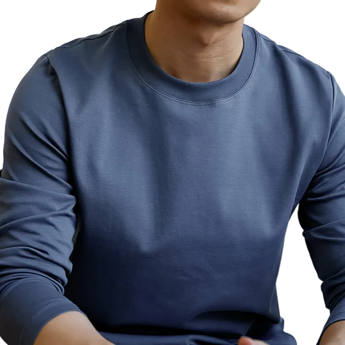 A close-up of a person wearing a long-sleeve crew-neck shirt in a muted slate blue color, showing the fabric texture and fit.