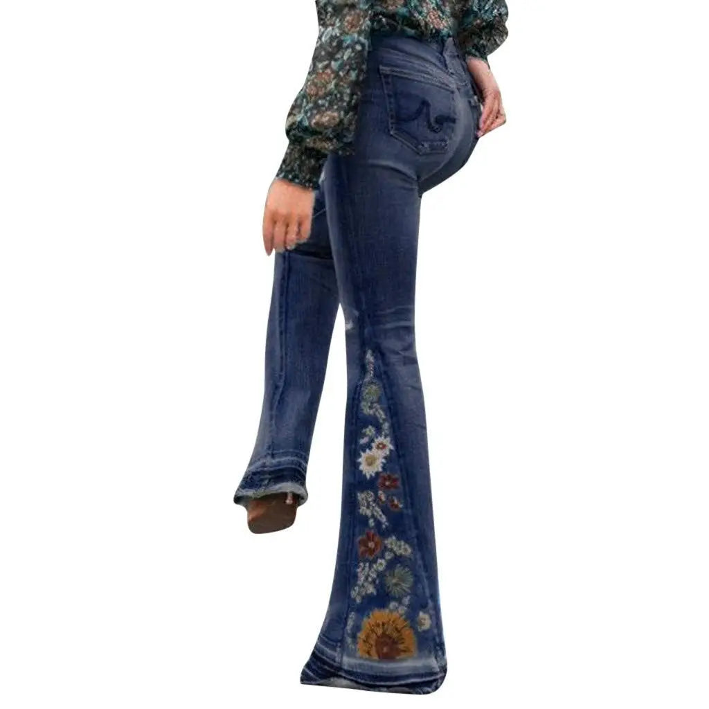 Flared jeans with floral embroidery on a white background