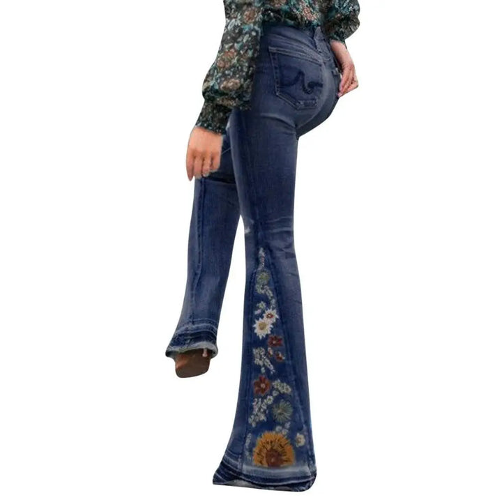 Flared jeans with floral embroidery on a white background