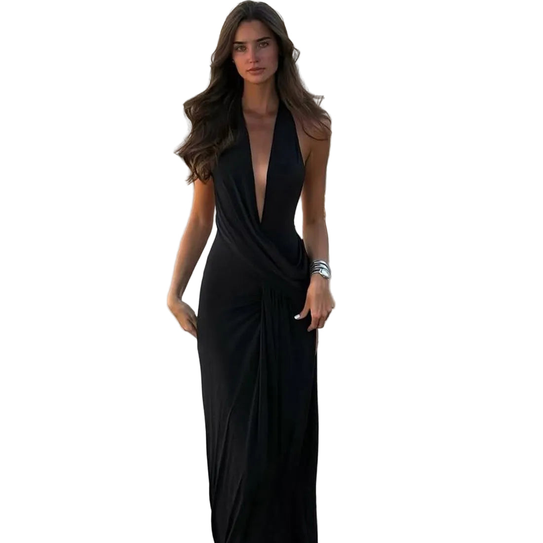 Woman in a black dress standing on a pathway with outdoor furniture in the background