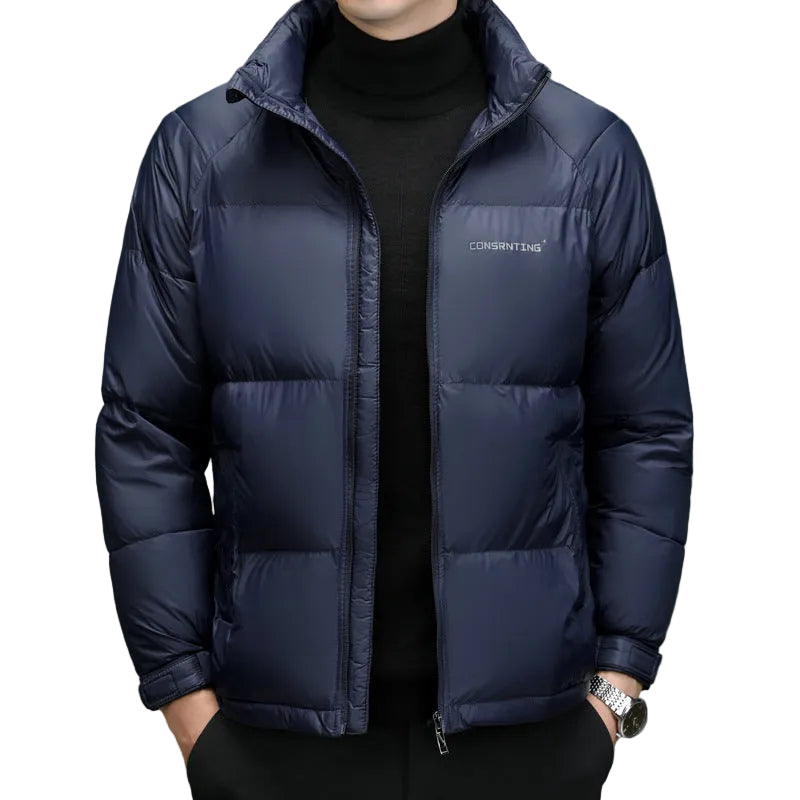 Navy blue puffer jacket with a brand logo on a gray background