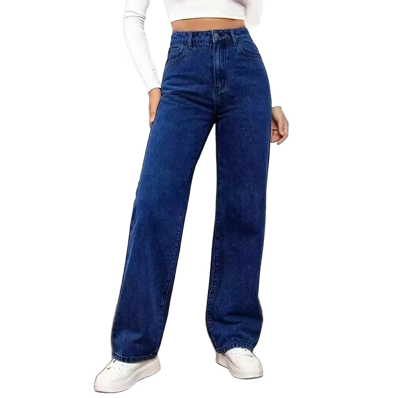 A model wearing a pair of dark blue high-waisted, wide-leg denim jeans, styled with a white long-sleeve crop top and white sneakers against a plain white background.