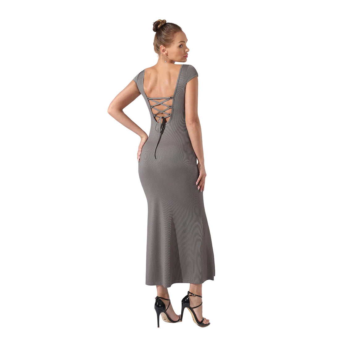 Woman wearing a gray dress with lace-up back on a white background