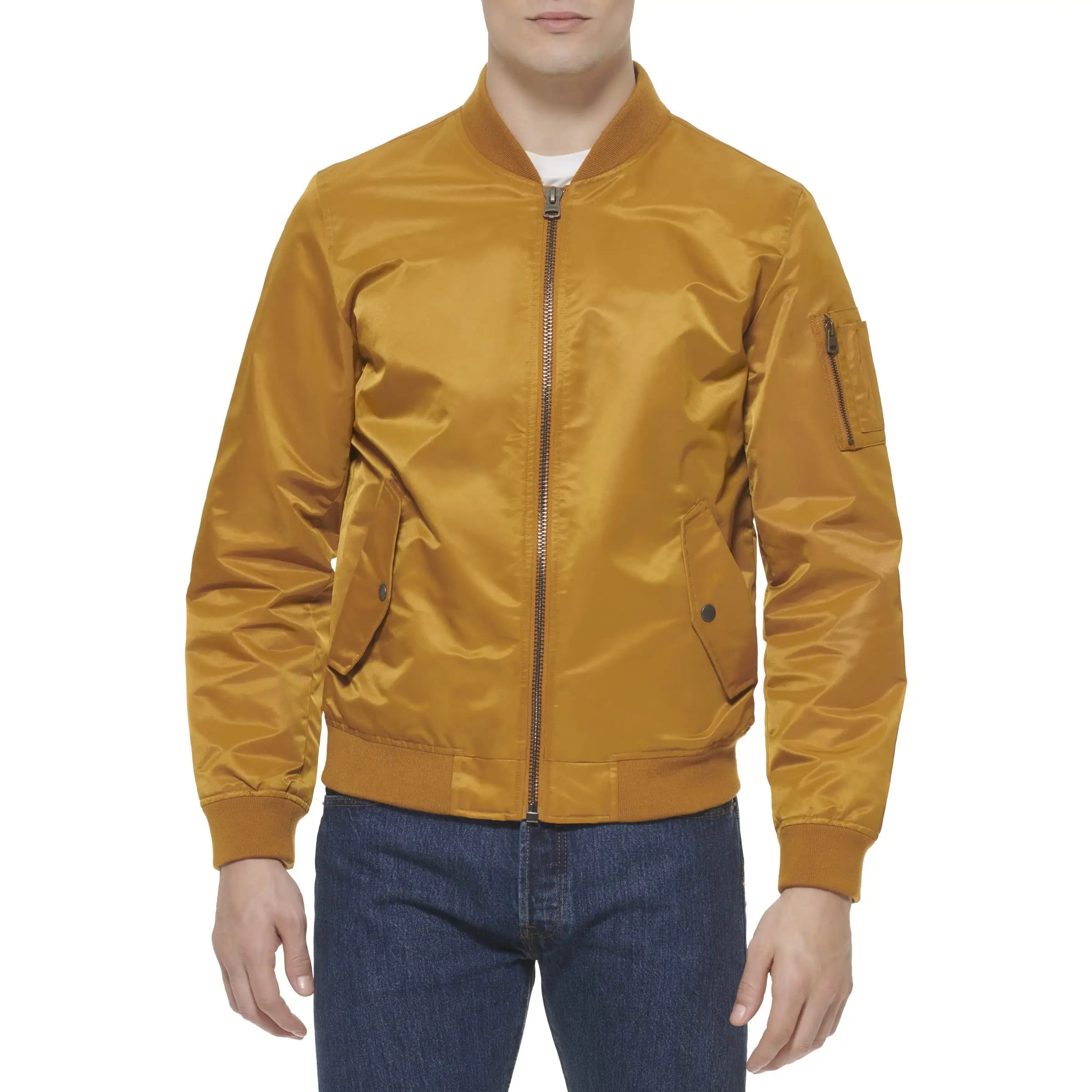 A man wearing a satin bomber jacket in a golden mustard color, paired with blue jeans, against a plain white background.