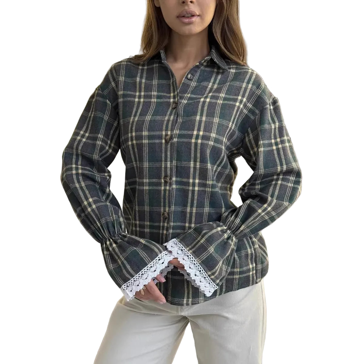 A woman wearing a dark green and beige plaid button-up shirt with dramatic bell sleeves and white lace trim at the cuffs, paired with light beige pants, seated in a modern living room setting.