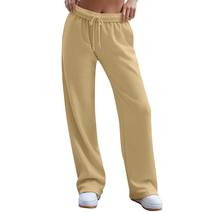 Beige sweatpants worn by a person on a white background