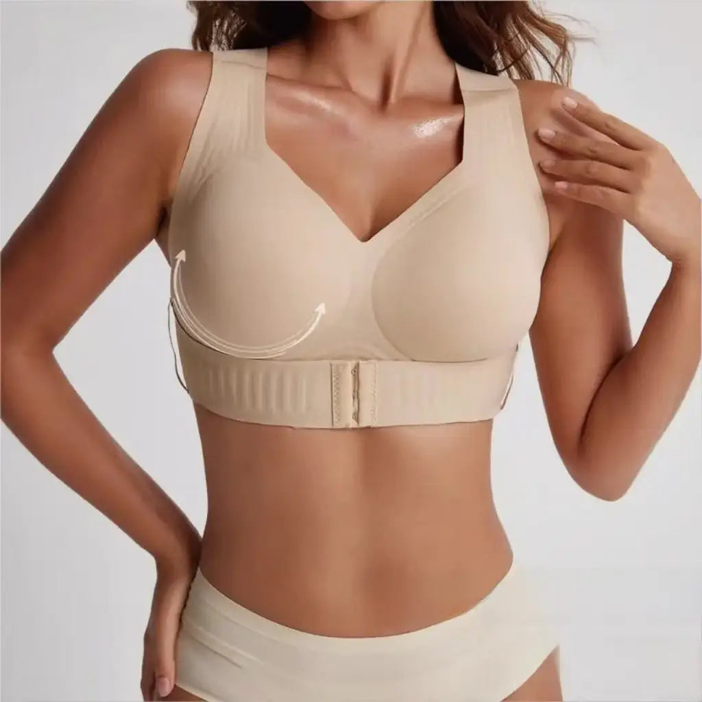A woman wearing a beige wireless supportive bra with a wide underband and matching underwear, shown against a light gray studio background with text reading 'new minimalist design' at the bottom right.