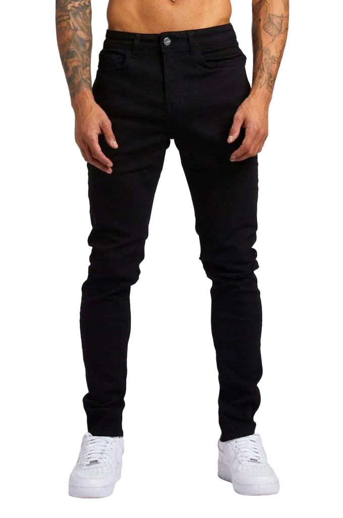 Person wearing black jeans and white sneakers on a white background