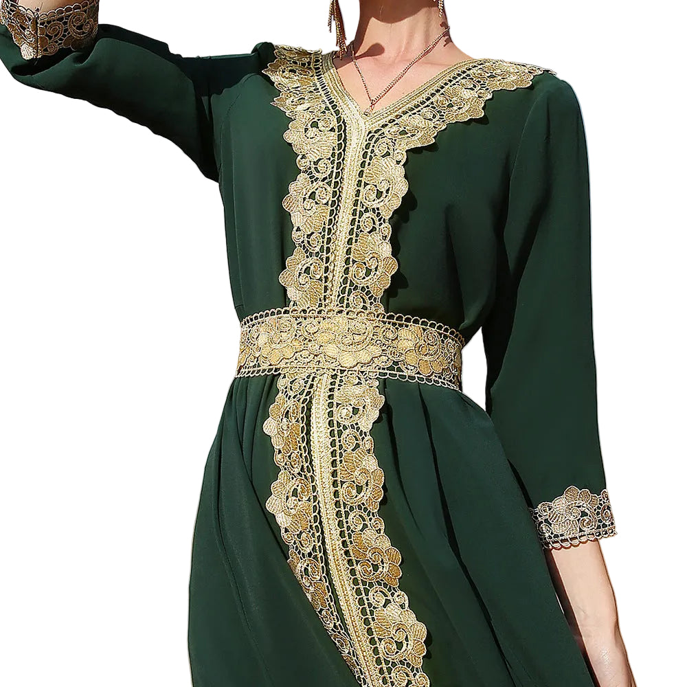 Green dress with gold lace details against a desert background