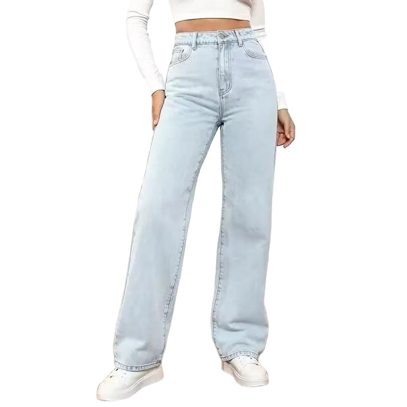 Light blue jeans worn by a person in a minimal indoor setting