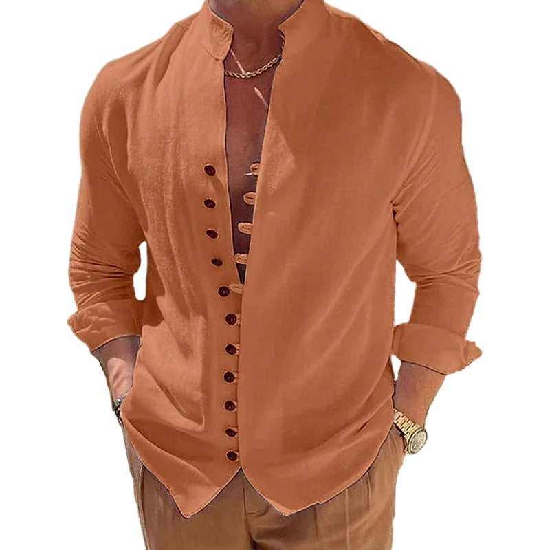 Person wearing a brown button-up shirt with a blurred outdoor background