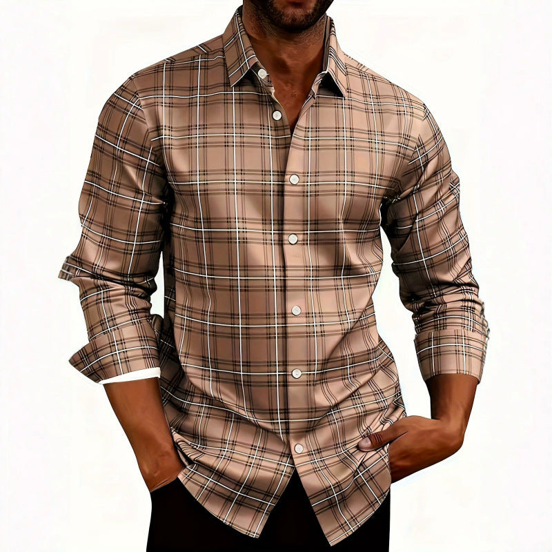 A man wearing a long-sleeve button-up plaid shirt in brown, beige, and black, with the sleeves rolled up to the forearms, set against a plain white background.
