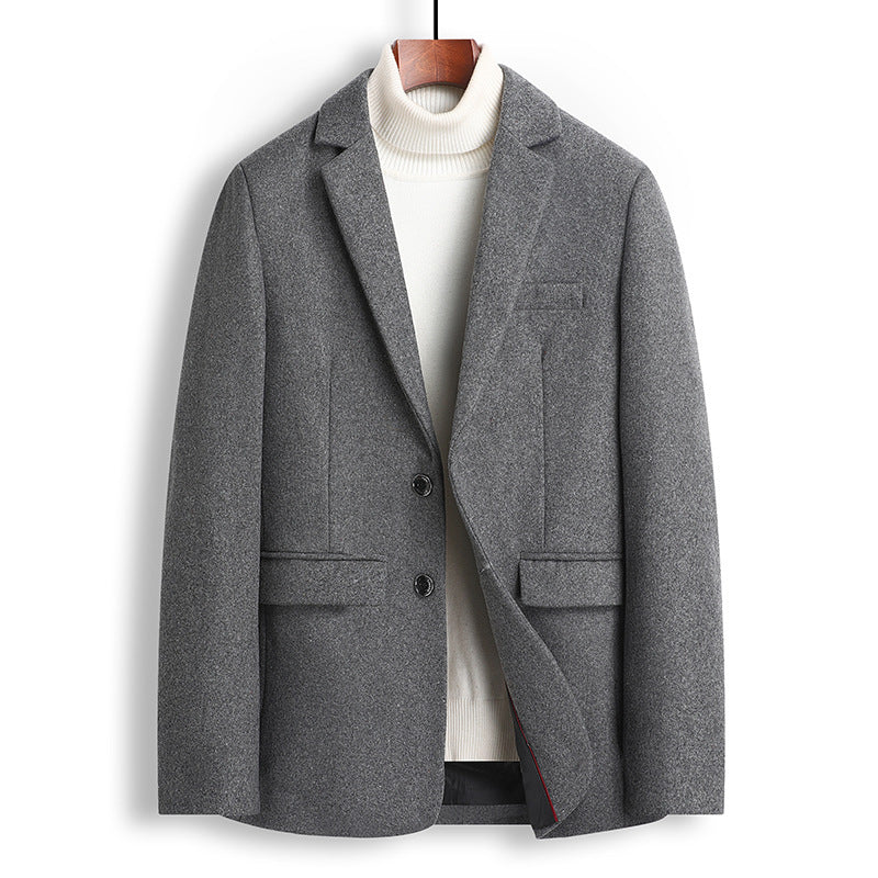 A men's gray wool-blend blazer jacket styled over a white ribbed turtleneck sweater, hanging on a wooden hanger against a plain white background.