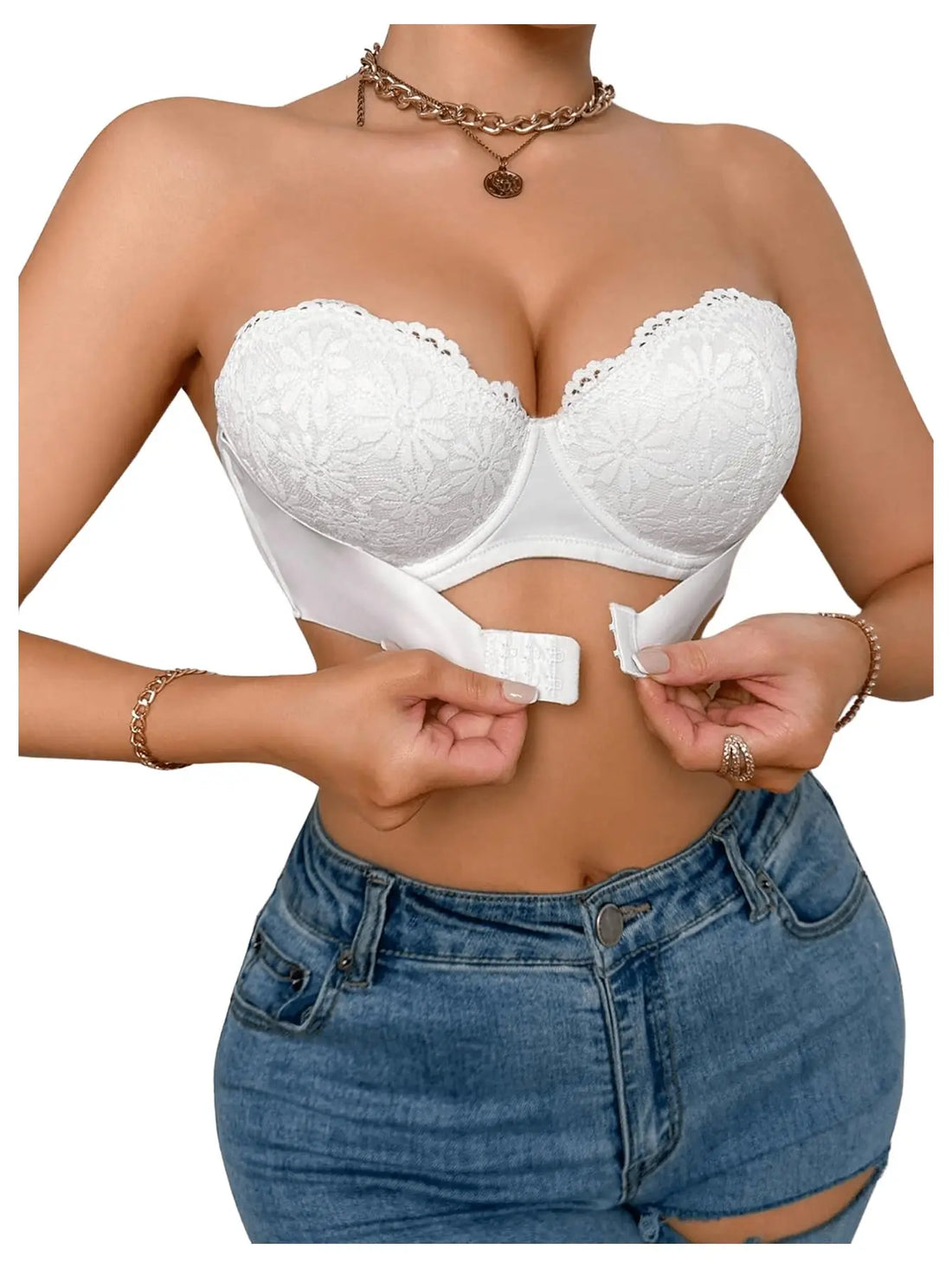 A white strapless lace bralette with underwire cups, shown on a model wearing blue jeans. The model is adjusting the front hook-and-loop closure of the bralette.