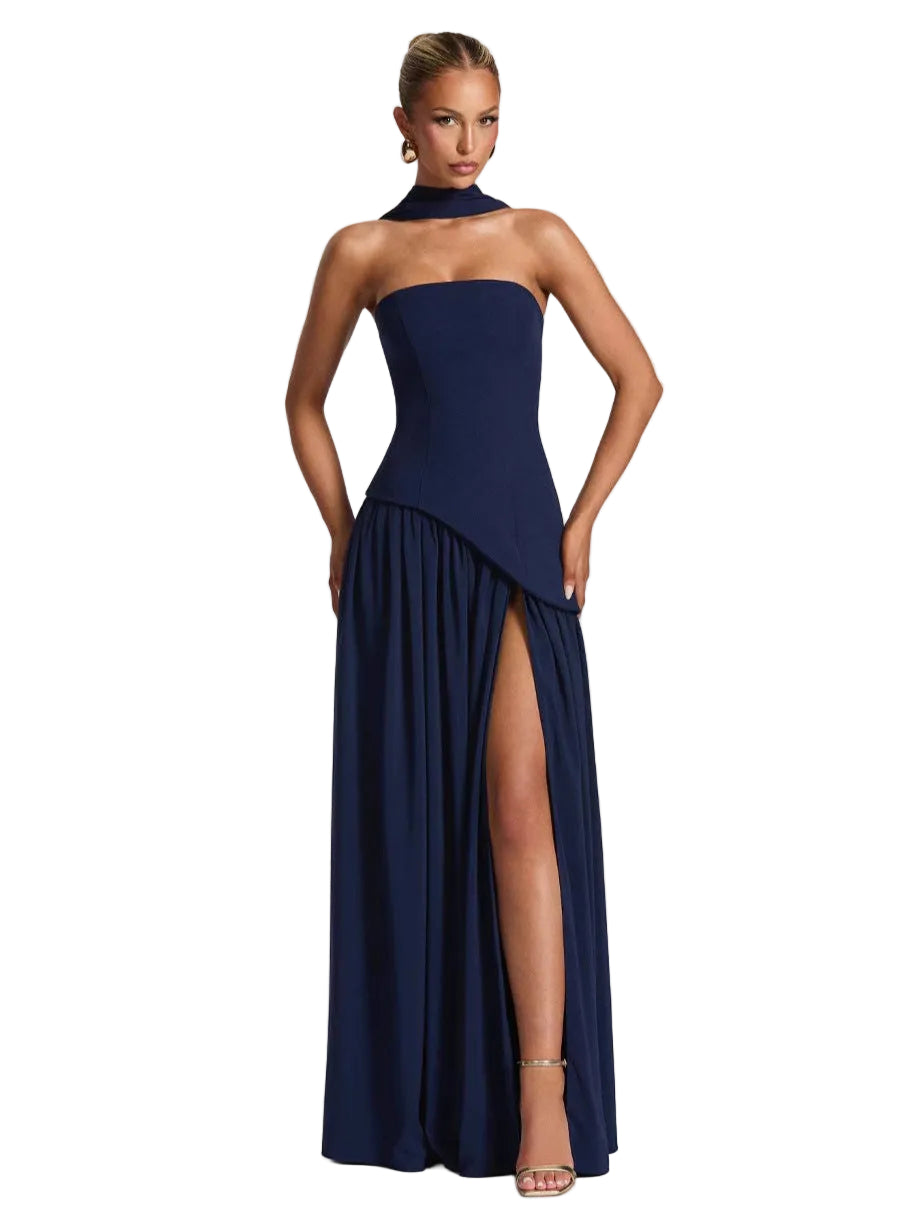 Navy blue strapless gown with a high slit on a white background