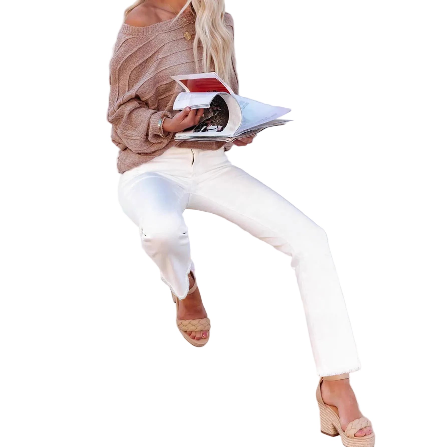 Woman sitting on a white chair reading a magazine against a white background