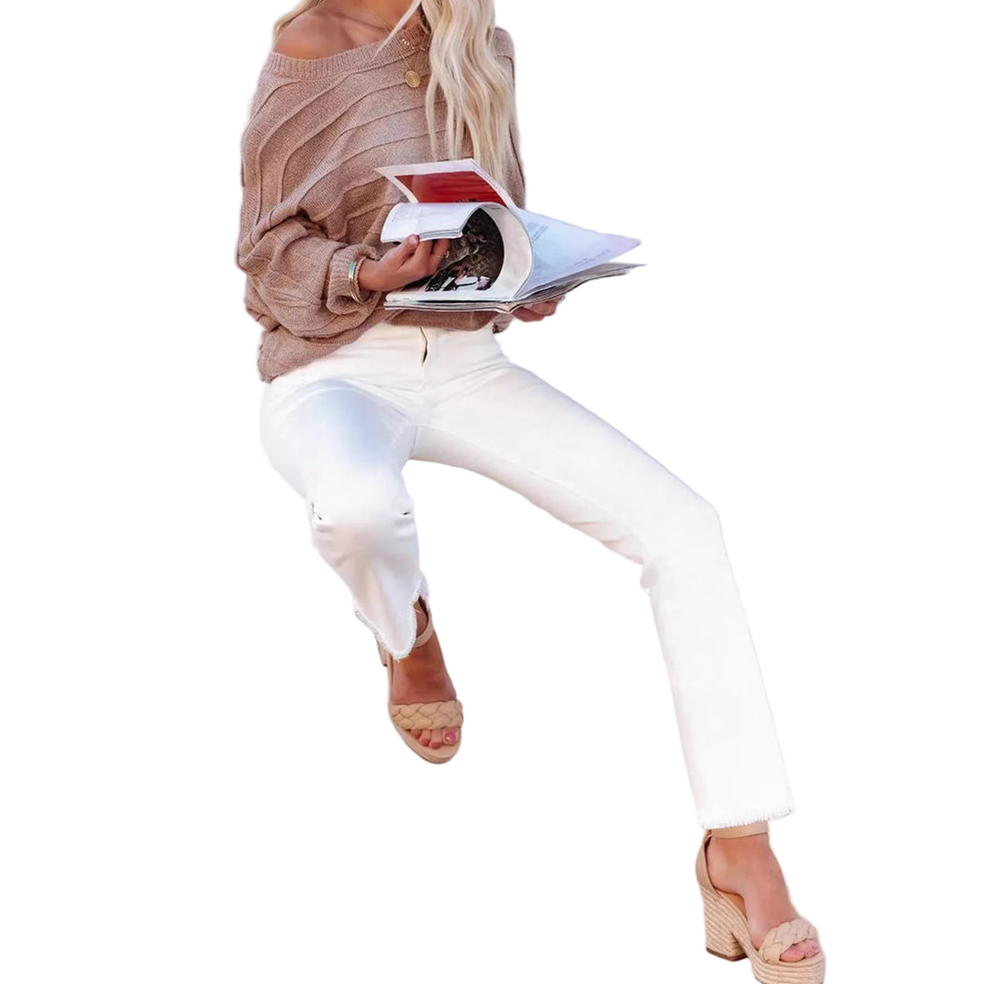 Woman sitting on a white chair reading a magazine against a white background
