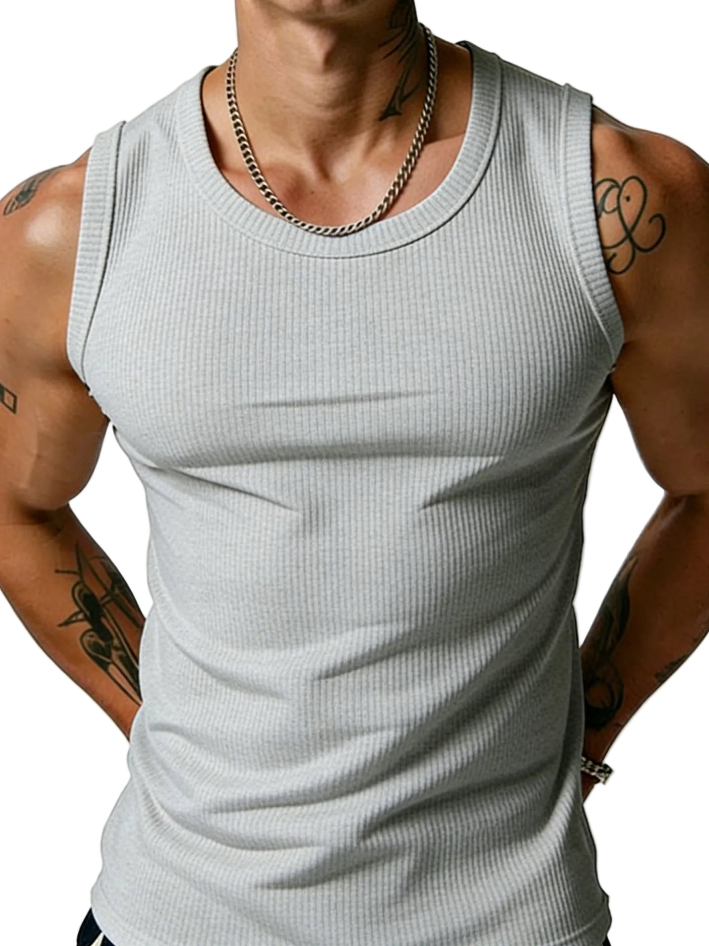Person wearing a gray tank top with visible tattoos on arms