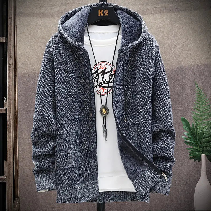 Blue knitted hoodie on a mannequin with a white shirt underneath, against a neutral background.