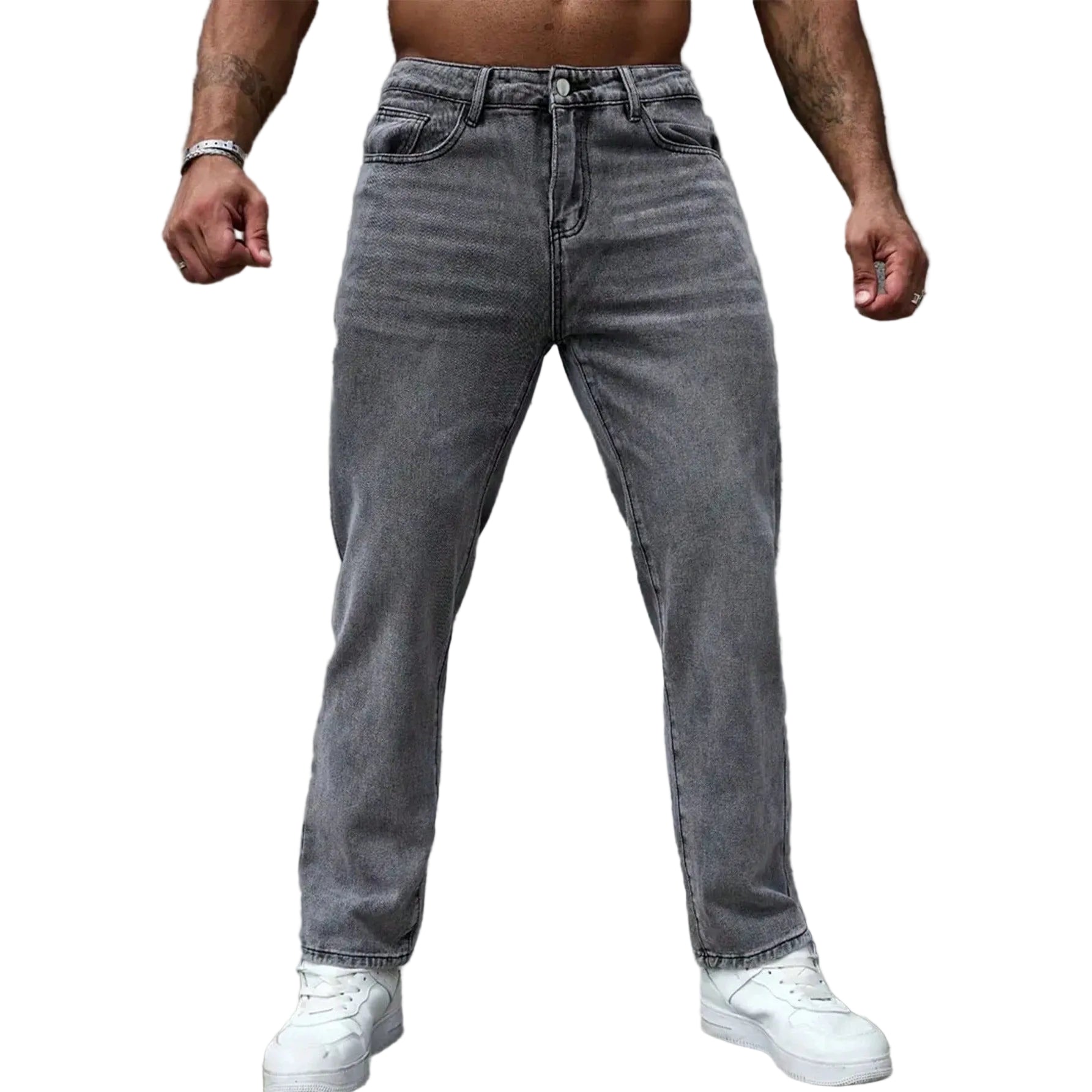 A man wearing gray washed denim jeans and white sneakers, shown from the waist down against a textured gray wall.