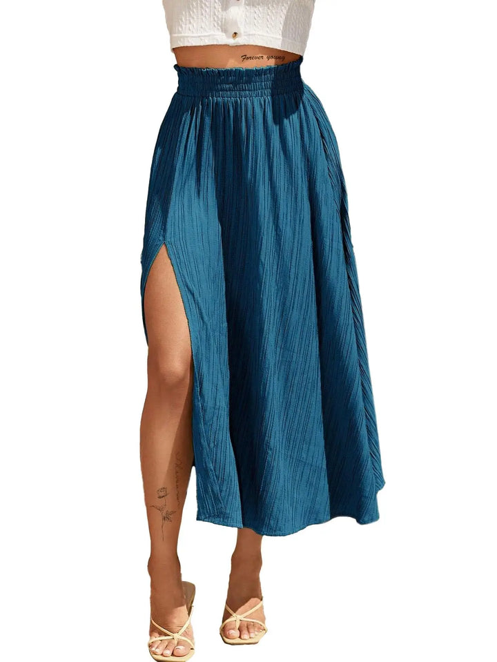 Blue skirt with a slit worn by a person on a white background