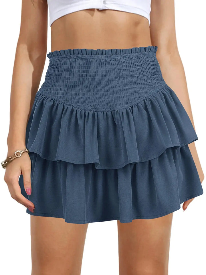 Blue tiered skirt worn by a person on a white background