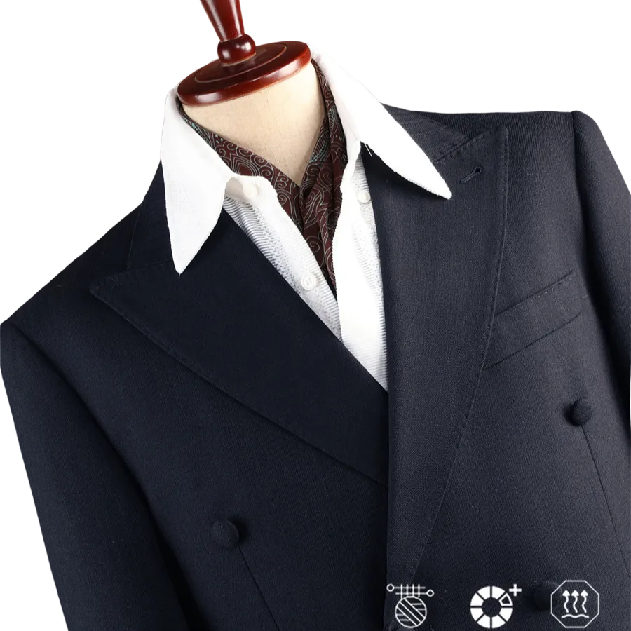 A dark navy double-breasted suit jacket displayed on a mannequin torso, styled with a white collared shirt and a brown patterned necktie, set against a solid terracotta background.