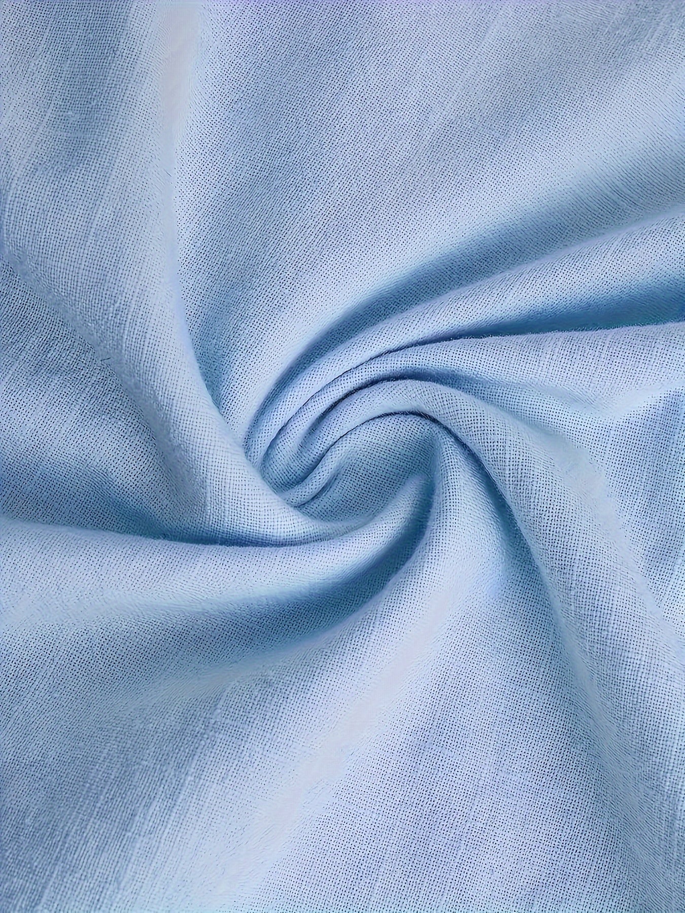 Close-up of light blue fabric with folds
