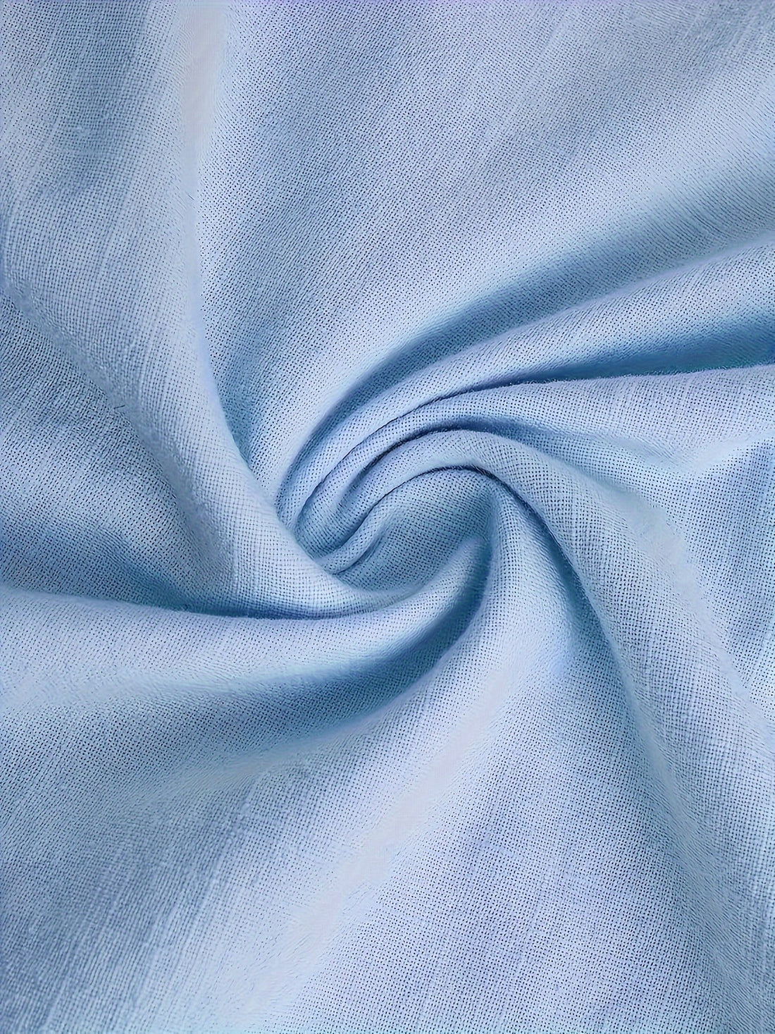 Close-up of light blue fabric with folds