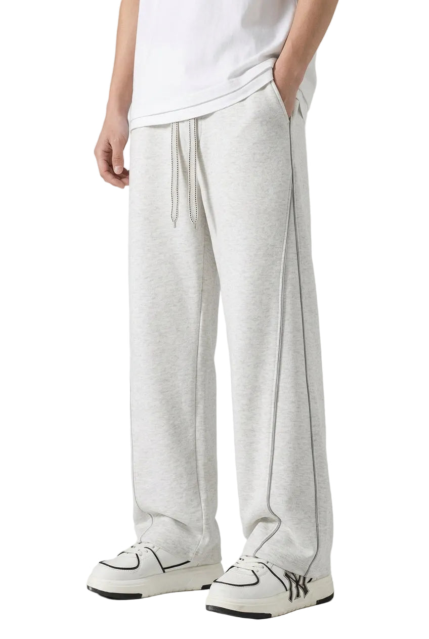 Person wearing gray sweatpants with a black and white logo on a gray background