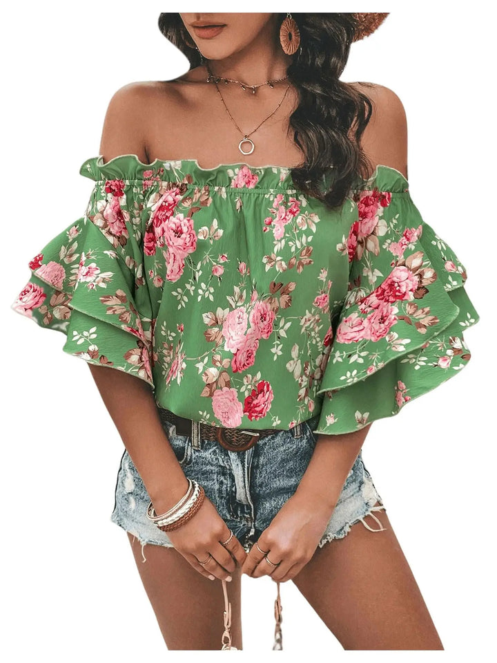 Green floral off-shoulder top worn by a model on a white background