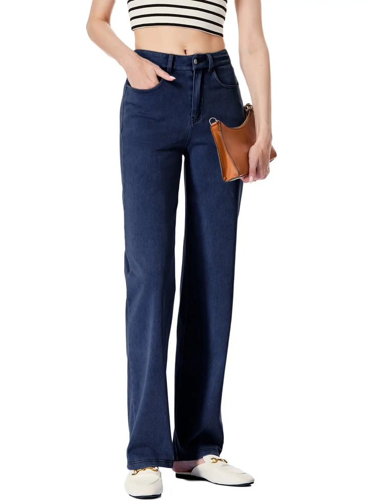 Person wearing blue jeans with a white background