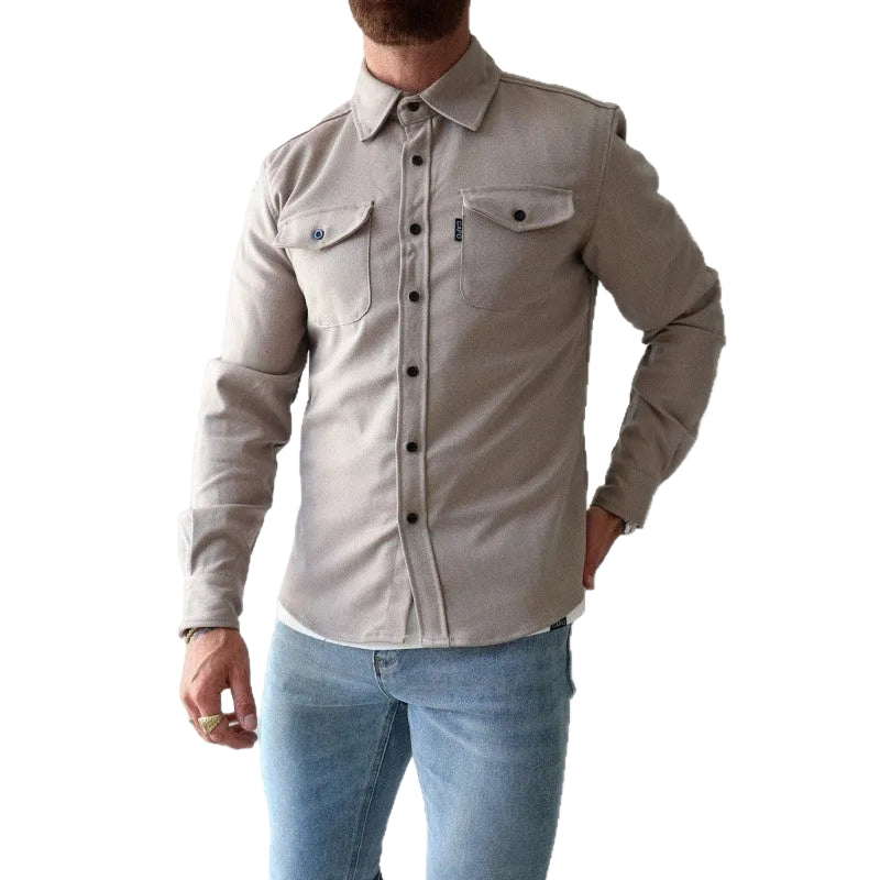 Man wearing a beige button-up shirt and light blue jeans on a white background
