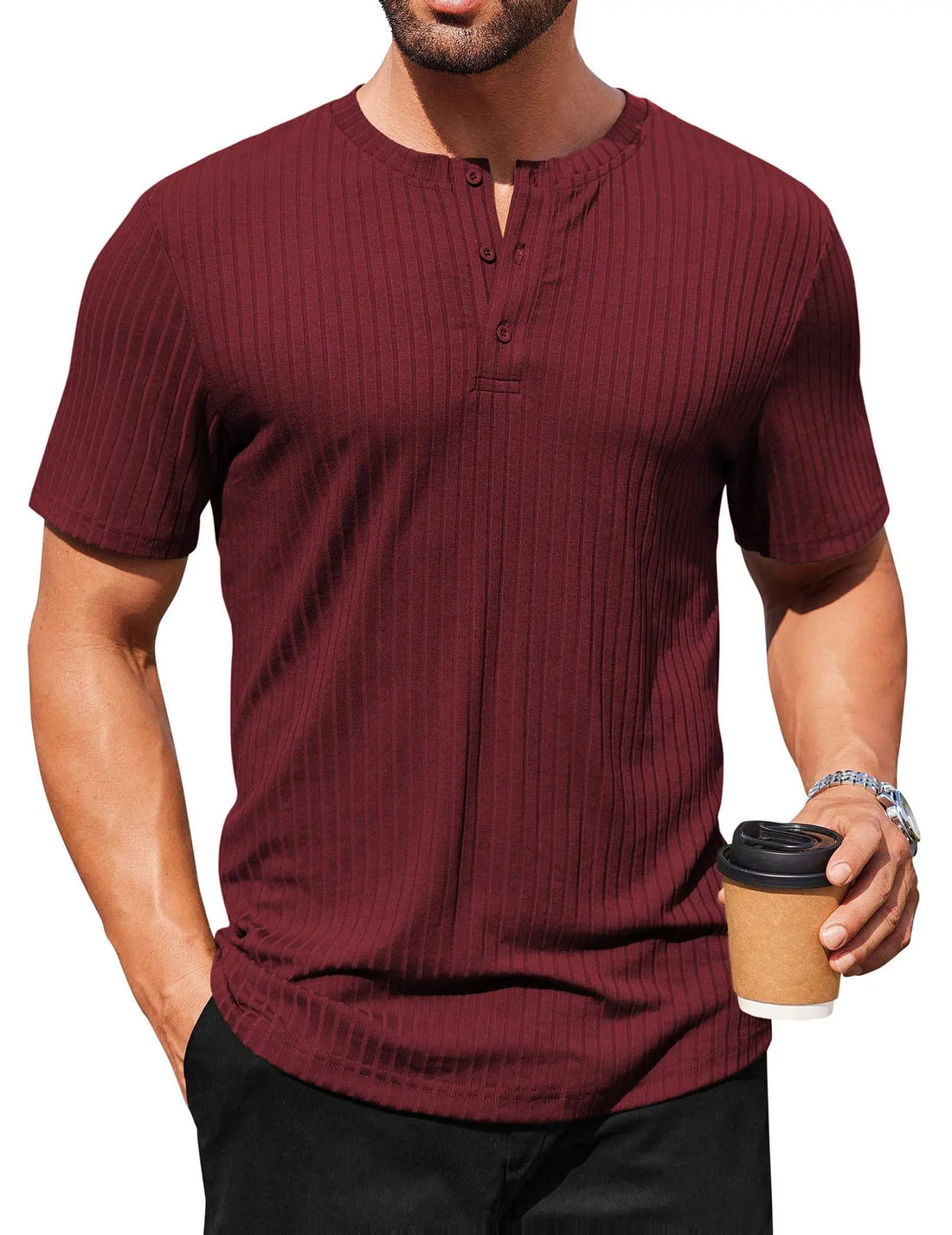 Man wearing a maroon ribbed henley shirt holding a coffee cup on a white background