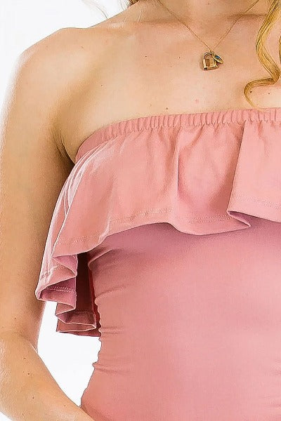 Pink strapless top with ruffled details on a white background