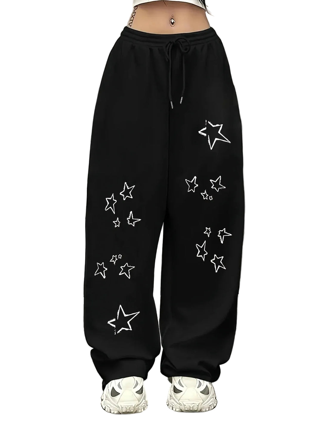 Black wide-leg sweatpants with white outlined star patterns, shown on a model from the waist down wearing white sneakers against a plain white background.