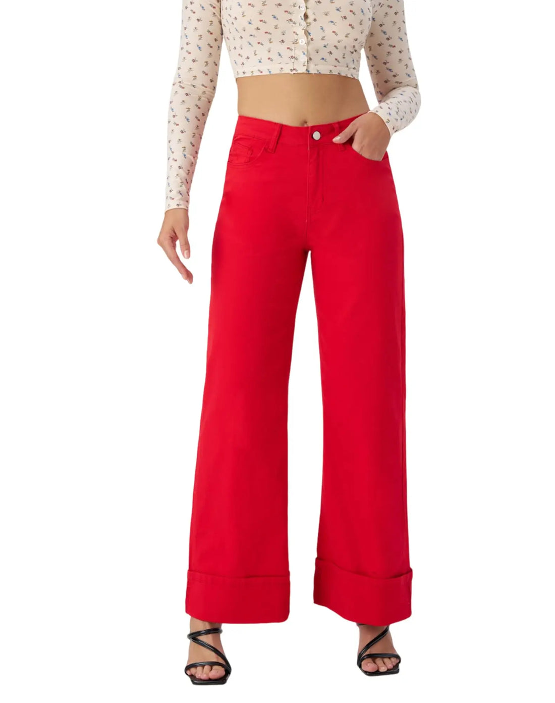Person wearing a white patterned top and red wide-leg pants on a white background
