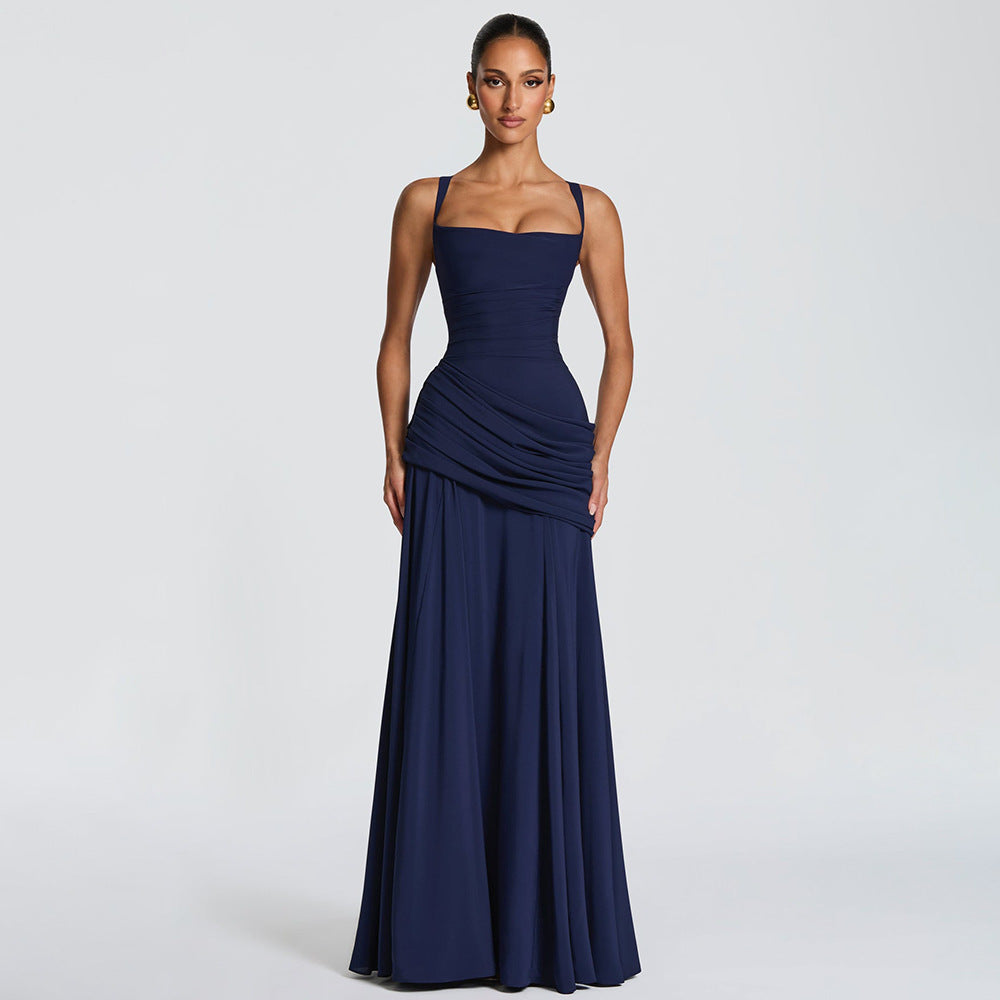 Woman wearing a navy blue evening gown on a light gray background