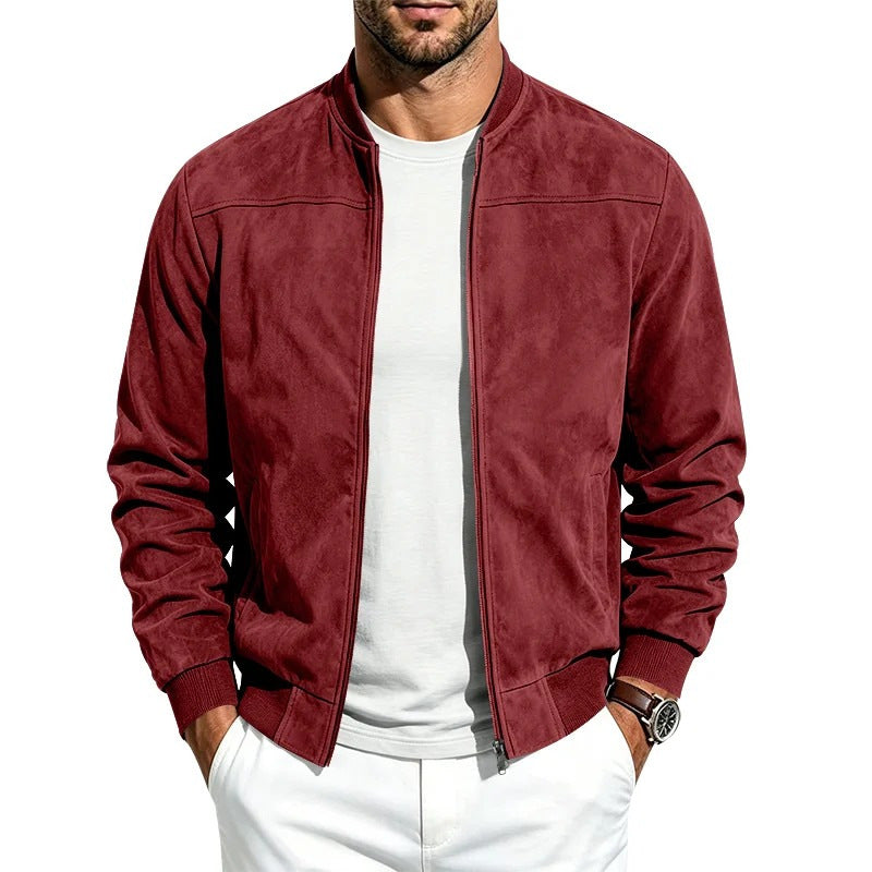 A man wearing a burgundy suede-textured zip-up bomber jacket over a white t-shirt and white pants, shown from the chin down against a plain white background.