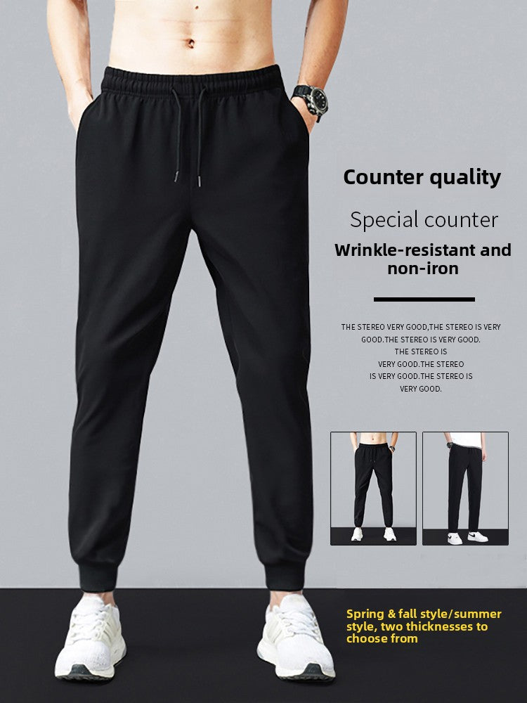 Black jogger pants worn by a person on a gray background with text about the pants' features.