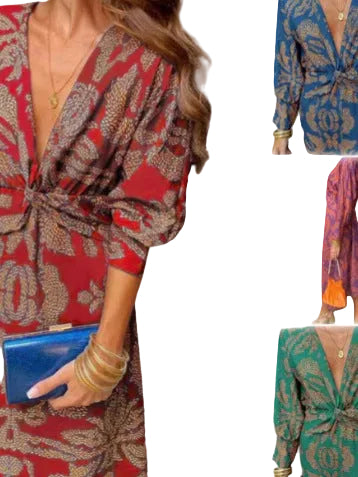 Woman in a patterned dress holding a blue clutch with a blurred indoor background