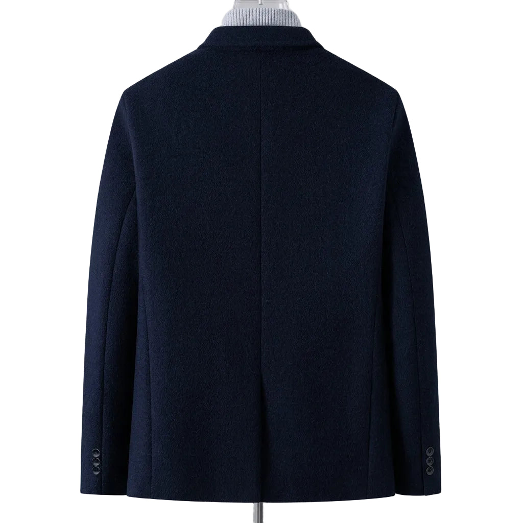 A dark navy blue men's coat shown from the back, displayed on a mannequin torso with a striped shirt collar visible at the neck. A flame graphic with the text 'Fleece-lined' appears in the lower right corner to indicate the lining feature.