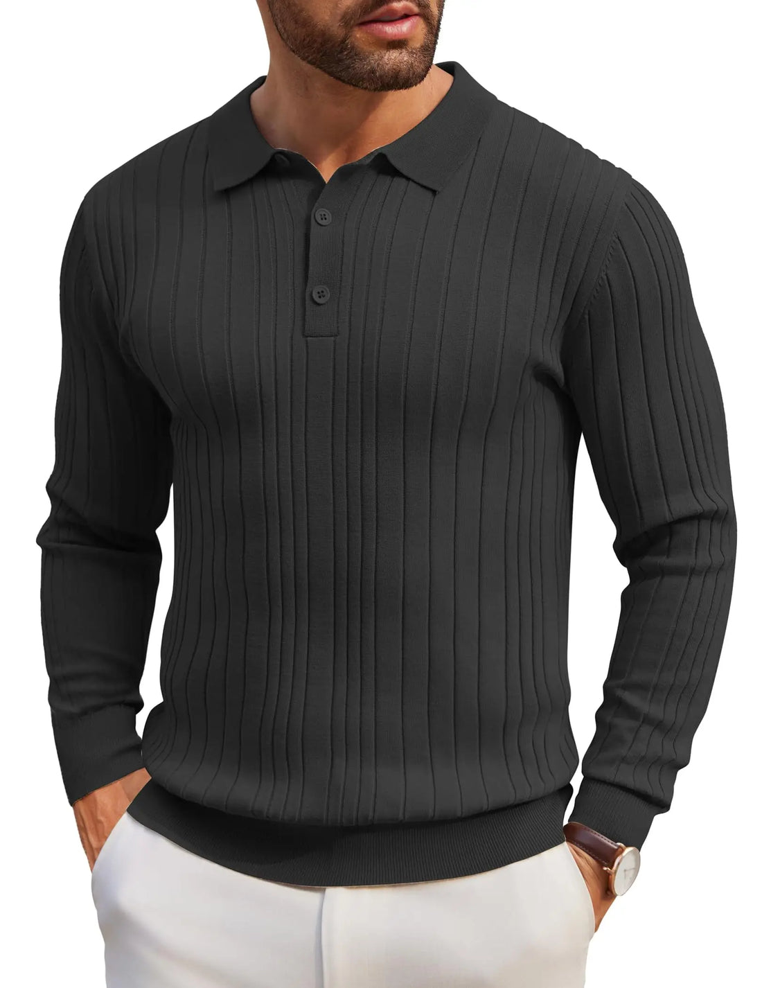A man wearing a dark charcoal gray ribbed long-sleeve polo shirt with white pants, shown from the chin down against a plain white background.